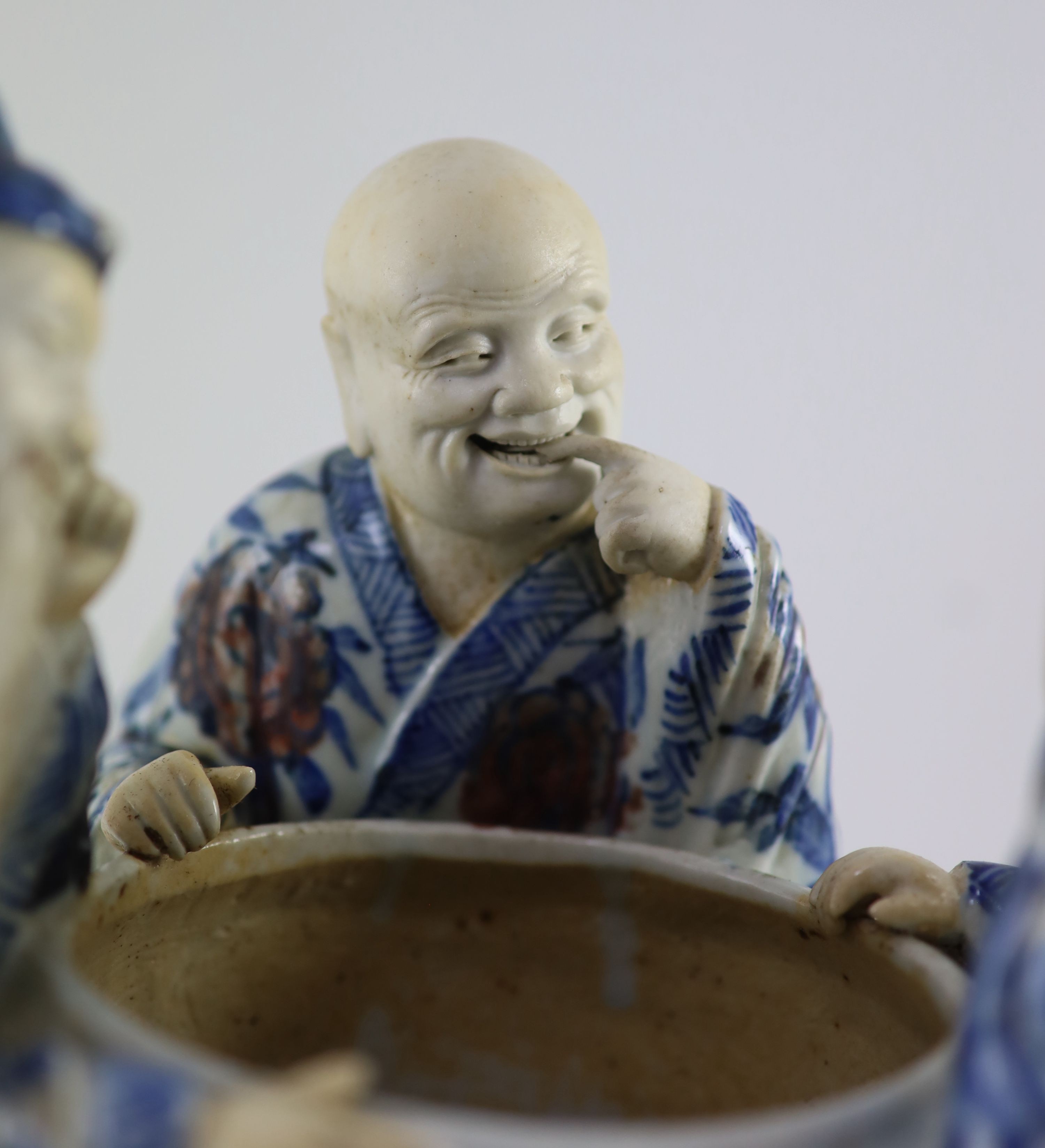 A rare Chinese underglaze blue and copper red porcelain model of the ‘Vinegar Tasters’, Qing dynasty, 26.cm high